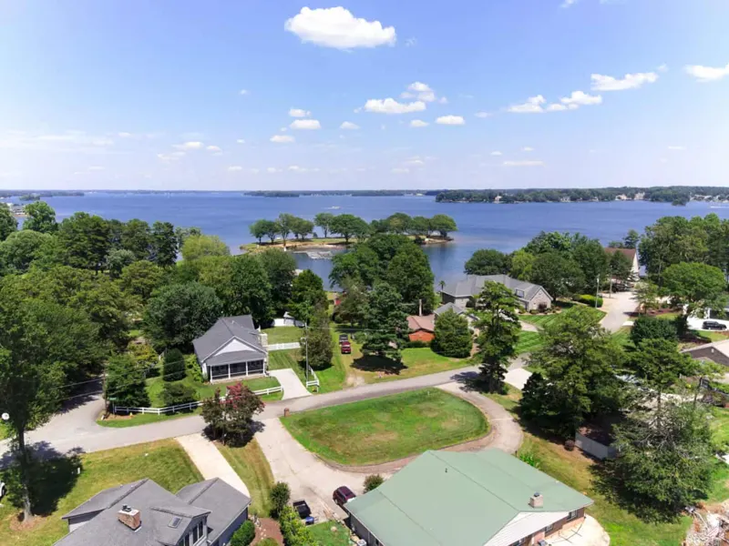 Aerial view over a lakeside neighborhood toward open water