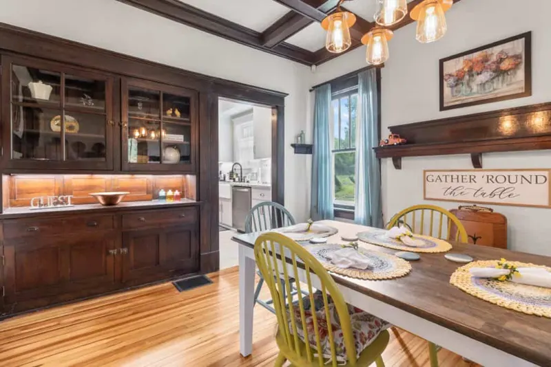 Dining area with dark built-in cabinetry and coffered ceiling