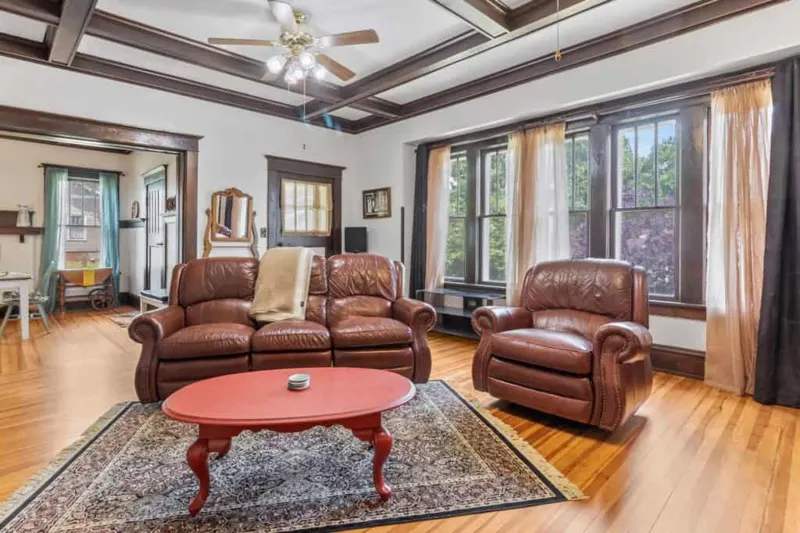 Living room with leather chairs and exposed ceiling beams
