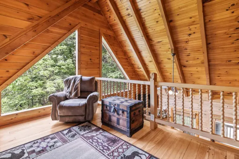 Pine-paneled loft with A-frame windows
