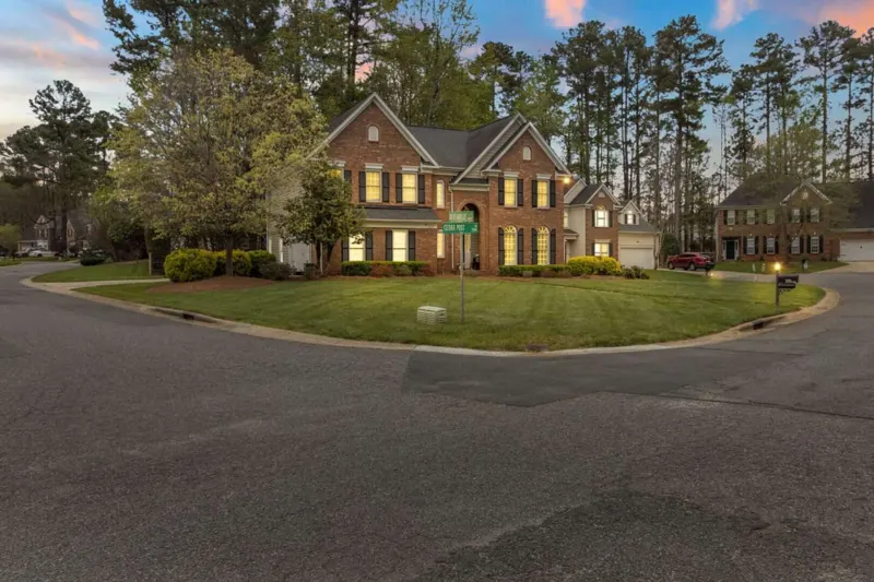 Two-story brick home on a cul-de-sac at dusk