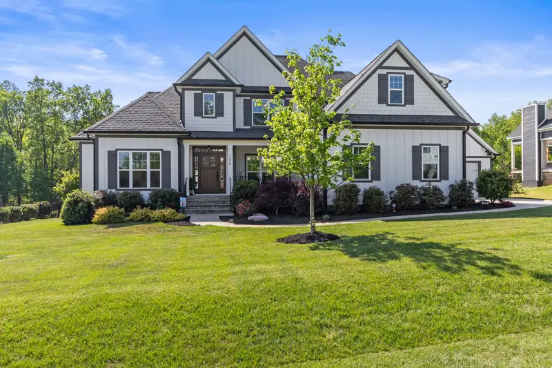 Two-story craftsman home with a wide green front lawn