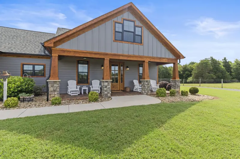 Modern farmhouse with timber gable and stone columns